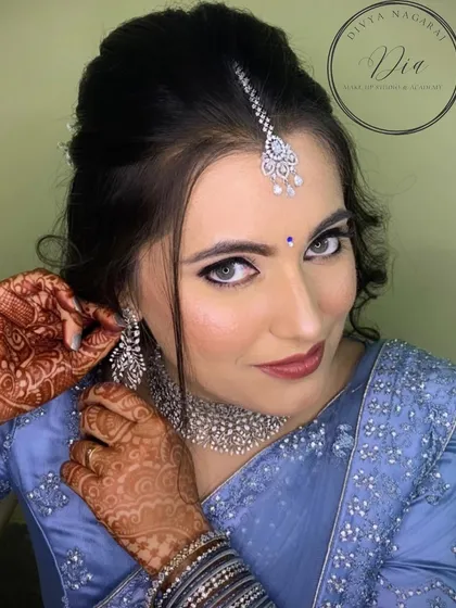 A close-up showcasing the "style and elegance" of this reception look. Her striking eyes are enhanced with sharp liner, paired with a soft pink lip and sparkling diamond jewellery.
