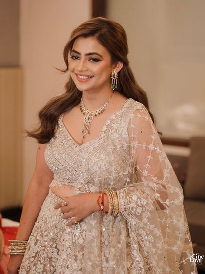 The Massi of the bride gleaming with joy. I gave her a soft glam look with a beautiful floral half-up hairstyle that was both elegant and modern.