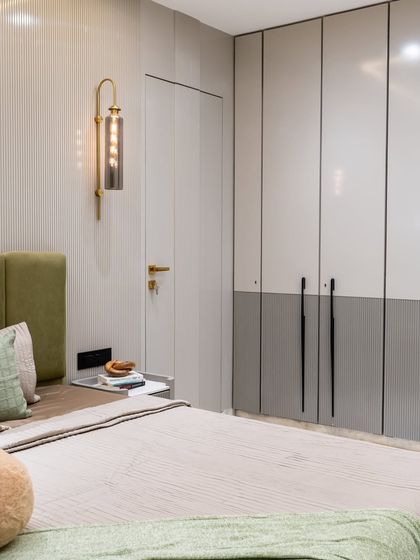 This dreamy daughter’s bedroom pairs muted grey wardrobes with a chic wall bracket light that sets the perfect ambient mood. The PU-finish louvred shutters add a refined texture, blending modern style with timeless comfort.