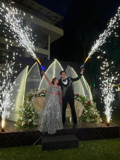 A celebratory moment with cold pyro guns. This is a fun and interactive way to add excitement to the sangeet night, creating dynamic photos and getting everyone in the party spirit.