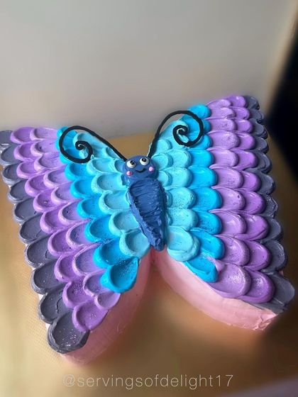 Another angle of the butterfly cake, showing the detailed piping work that gives the wings their beautiful, layered look.