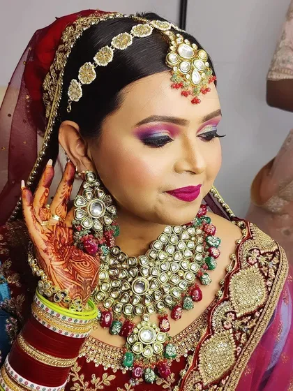 Another angle of this stunning bride, highlighting the flawless contouring and the way the makeup complements her features and her bridal jewelry.