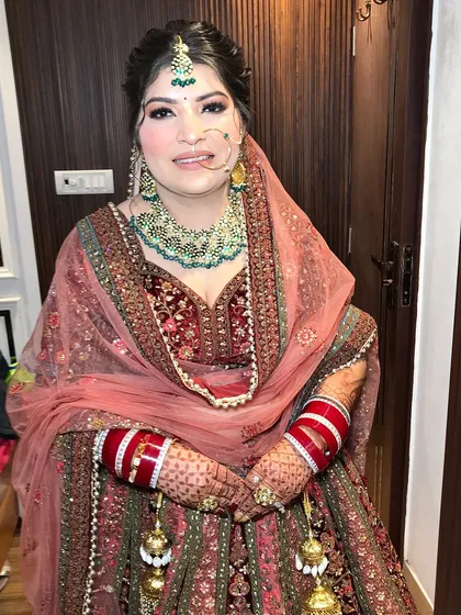 A happy bride, her smile as bright as her jewelry. The kaleeras add a traditional touch.