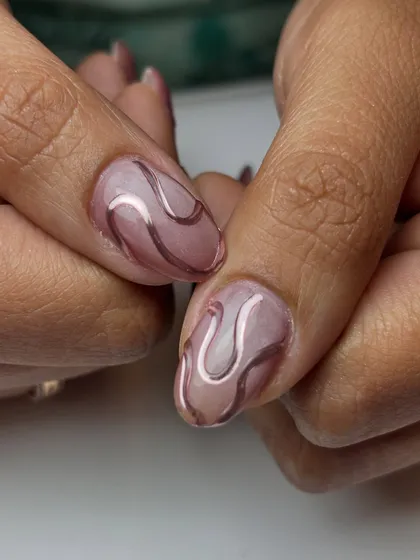 A close-up of the 3D chrome heart design over the cat-eye base. The raised chrome adds a tactile element to the nail art.
