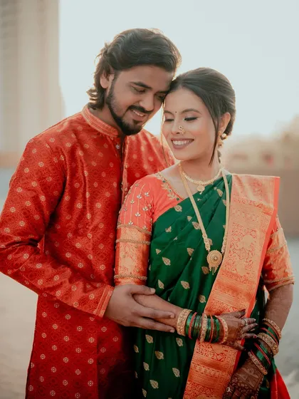 An intimate moment between the couple, with the bride's glowing makeup and traditional attire taking center stage.