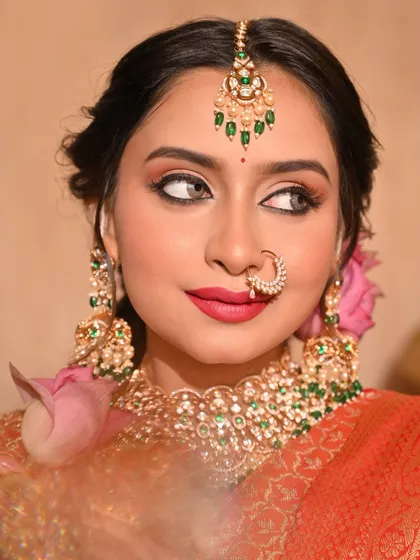 A side profile of the model, showing how the lotus flower complements the traditional jewellery and makeup.