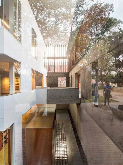 Reflections on the glass facade of the Lilavati Lalbhai Library merge the new structure with the historic context of the CEPT University campus. This visual layering connects past and present, a key principle in our approach to institutional design.