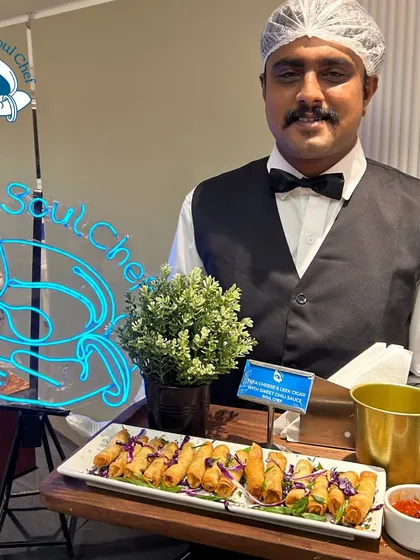 A server presenting a tray of crispy spring rolls, a classic crowd-pleaser for any event.