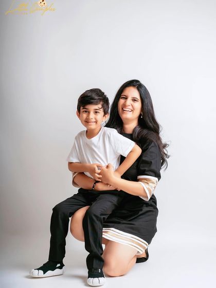 A happy mother and son portrait against a simple studio background. Their smiles are infectious!