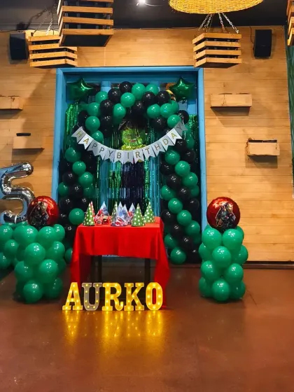 A full view of a green and black themed birthday setup, perfect for a variety of boys' themes. The marquee letters add a personalized touch.