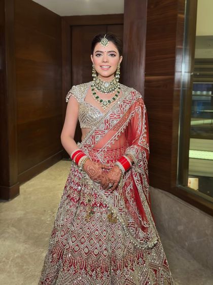 A full-length shot showcasing the entire bridal ensemble. The makeup provides a radiant focal point that completes the look.