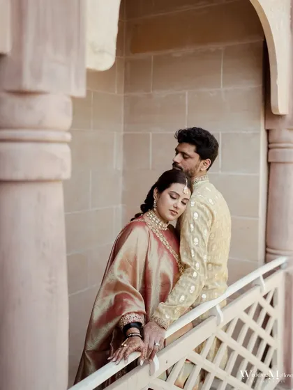 An intimate and tender portrait of the couple. The bride rests her head on the groom's shoulder, a quiet moment of comfort and love captured beautifully.
