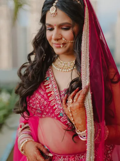 Soft, glowy skin paired with elegant details. This bride's look in a pink lehenga is timeless, with her beautiful smile being the main showstopper.