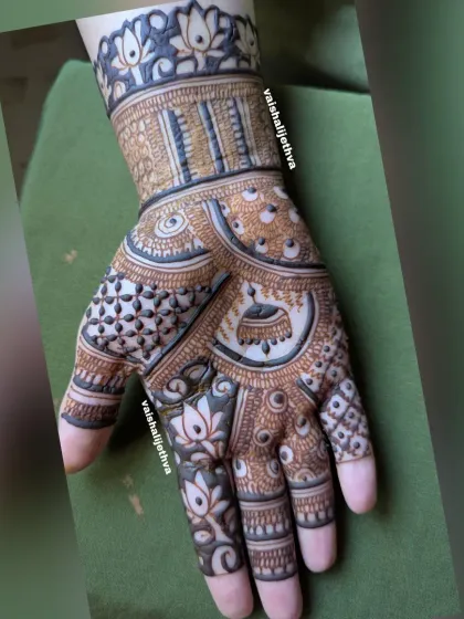 This design incorporates jhumka (bell) motifs with lotus patterns and varied check fills for a rich, textured look.