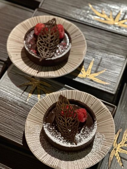A decadent chocolate tart for all the chocoholics. Topped with fresh raspberries and an intricate chocolate leaf, this dessert is both rich in flavour and elegant in presentation.
