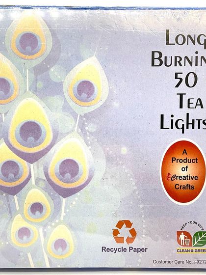 The back of the blue peacock-themed box, noting that it is a long-burning product and made with recyclable paper.