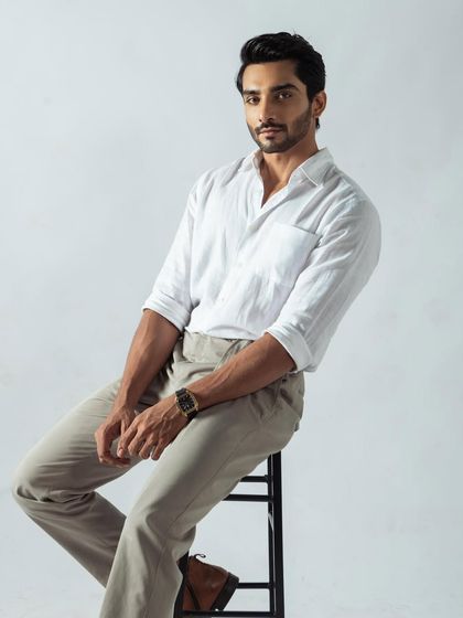 A clean, classic menswear shot. The simple styling and confident pose make this a perfect headshot for a male model's portfolio.