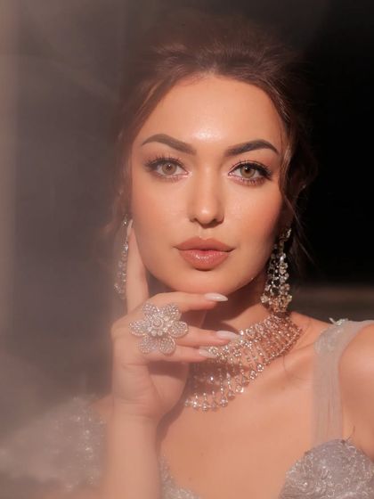 Another beautiful portrait, her hand gently touching her face.