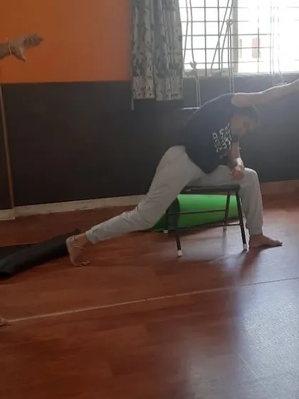 This duplicate view emphasizes the focus and concentration that chair yoga encourages. It's a mindful practice that connects breath with movement, even in a modified form.