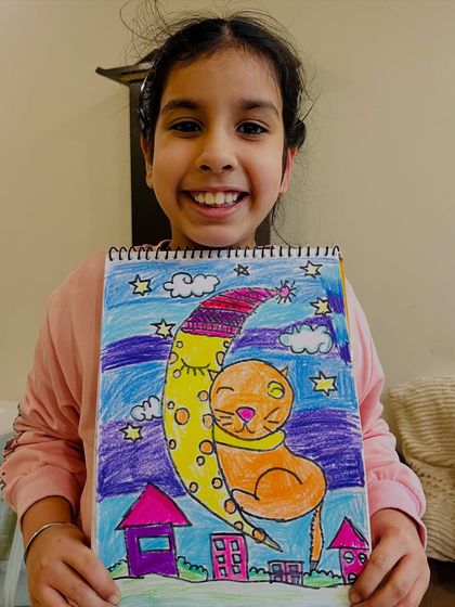 A whimsical drawing of a cat on the moon, inspired by the popular Ghibli art style. We always encourage students to explore trends they love.