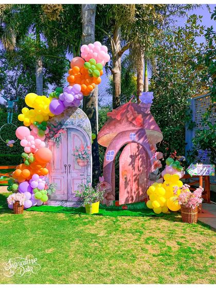 I created these charming, hand-painted fairy house doors as a key feature of the enchanted garden theme. Surrounded by colourful balloon garlands, they look like a real gateway to a magical realm.