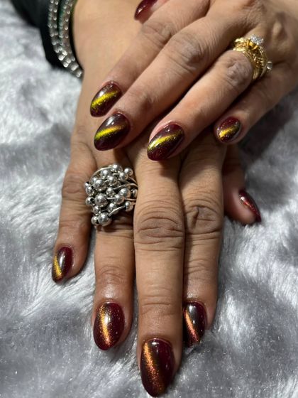 Flawless and ready to steal the spotlight. These stunning nails feature a deep red and gold cat-eye effect that creates a beautiful, shifting pattern.