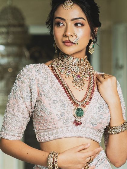 Twirl into a fairytale with this baby pink bridal lehenga. I designed it with intricate horse embroidery on the raw silk skirt and paired it with a heavily handworked blouse and a delicate net dupatta for a truly heavenly look.