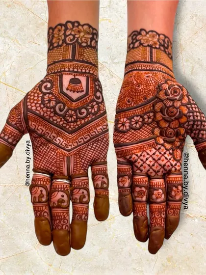 A beautiful blend of Indian and floral elements. This design features a temple bell motif on one hand and dense floral and grid patterns on the other, with tiny elephants on the fingers.