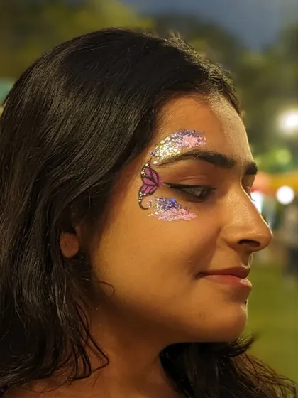 A dreamy butterfly design created with clouds of purple and pink glitter.