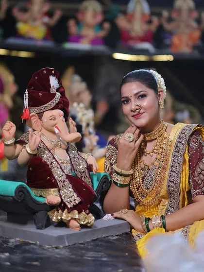 A close-up with Bappa, highlighting the detailed temple jewellery and the traditional Maharashtrian nath.