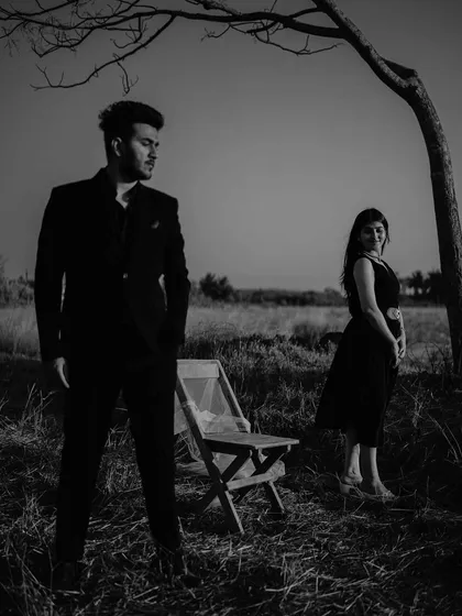 A dramatic black and white composition using the stark tree and open space. This shot has a moody, artistic feel, like a still from an old romantic film.