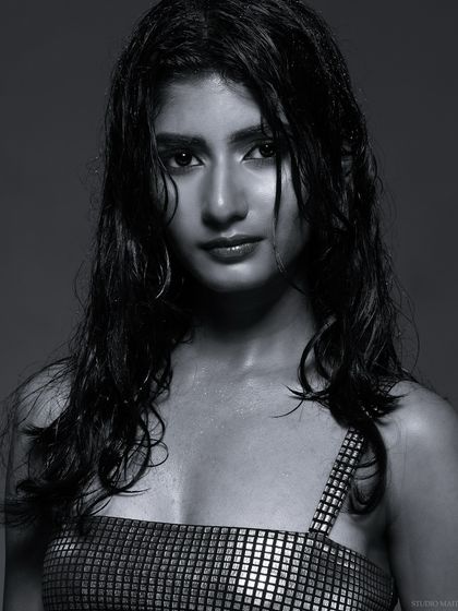 An intense black and white close-up, focusing on the model's expression.