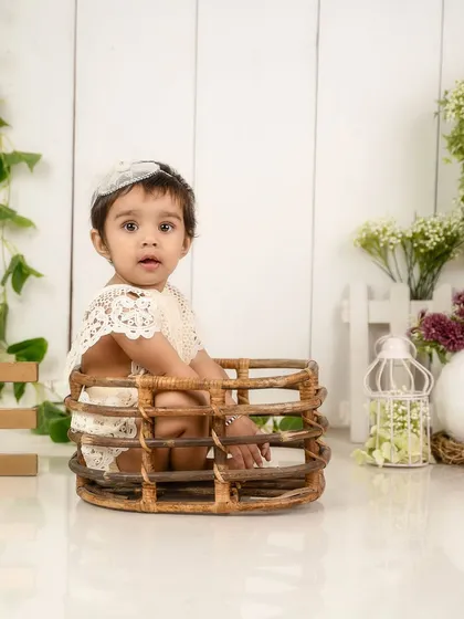 Peeking out of a basket. Using simple props like this can help a baby feel secure and lead to adorable, curious expressions.