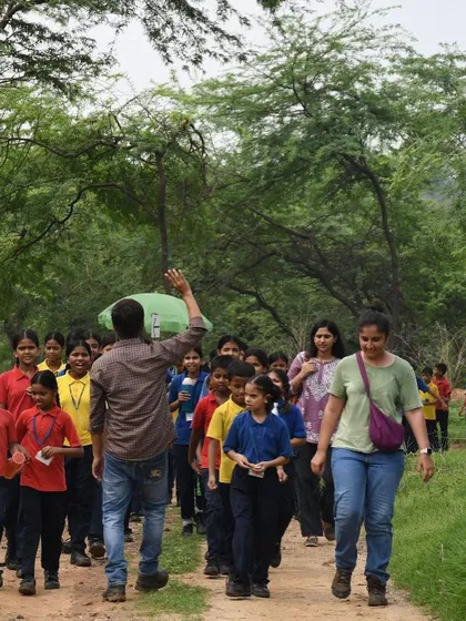 Our team leads a group of enthusiastic students on a walk through the Aravali Nagar Van, teaching them about the forest they are helping to restore.