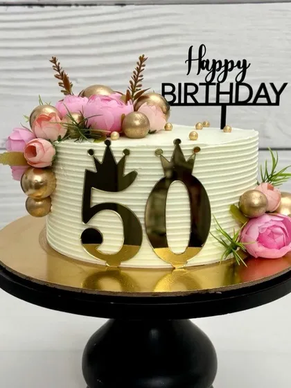 Elegant floral vibes for a fabulous 50th! This cake is decorated with pink peonies, gold spheres, and a bold '50' topper, making it a perfect centerpiece for a milestone birthday.