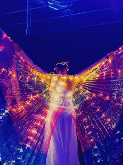 A performer with LED wings lighting up the stage on New Year's Eve. We incorporate live performers to make special events even more spectacular.