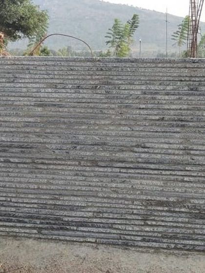 A full-scale mock-up of the load-bearing wall for the Nandi Hills house. The stacked granite off-cuts create a highly textured, monolithic surface that is both sustainable and deeply connected to its location.