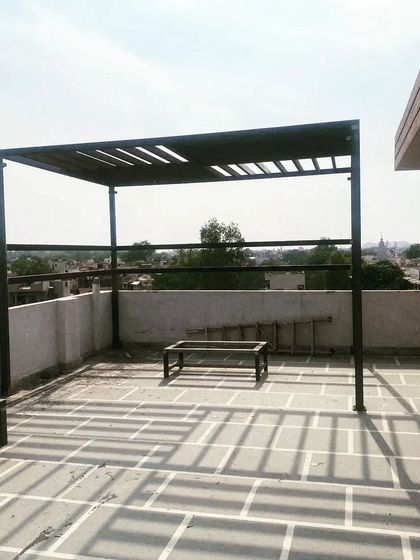 A full view of the simple and elegant black MS pergola.