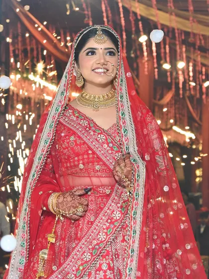 A candid moment of pure happiness. Bhawna looked absolutely radiant for her wedding, with her natural bridal makeup glowing under the lights and sparklers.