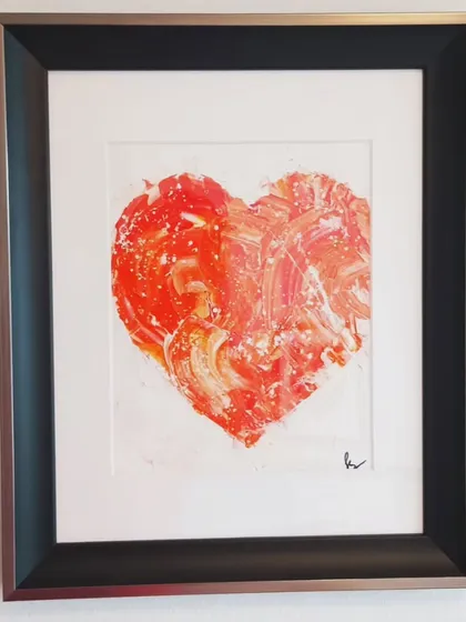 The framed red textured heart, a symbol of passion and love. This piece, with its vibrant color and simple frame, can be a stunning focal point in a living room or bedroom.