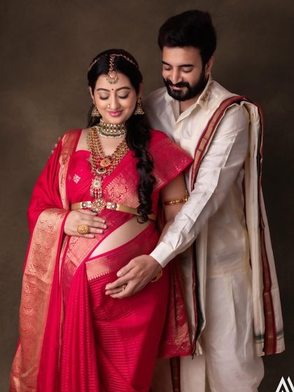 A beautiful moment between the parents-to-be. The makeup is soft and radiant, celebrating this special time.