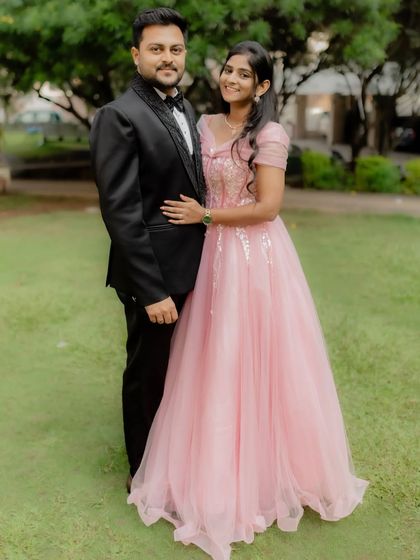 A perfect match in every way. This couple celebrated their engagement in our elegant pink gown and a classic black tuxedo, both available for rent.