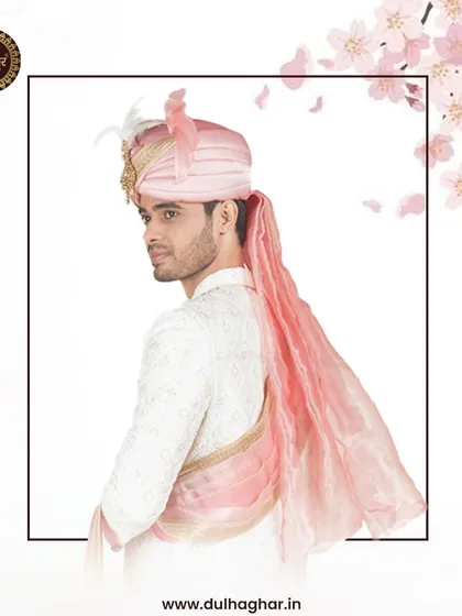 A side view of the white and pink sherwani, highlighting the flow of the fabric and the elegant drape of the stole.