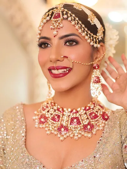 A complete bridal look featuring one of my classic red Meenakari and Kundan necklace sets. This rental set includes a choker, matching matha patti, nath, and earrings, designed for the traditional bride.