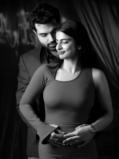 A classic, moody black and white portrait of a couple in an intimate embrace. This studio-style shot demonstrates our versatility in creating artistic and timeless couple photography.