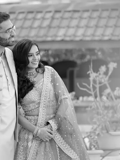 A timeless black and white portrait of the couple, capturing a quiet, candid moment.