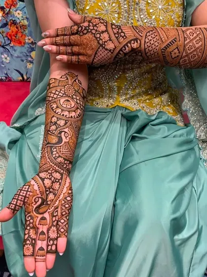 A beautiful peacock-themed design that flows from the palm up the arm, perfect for a bride or bridesmaid.
