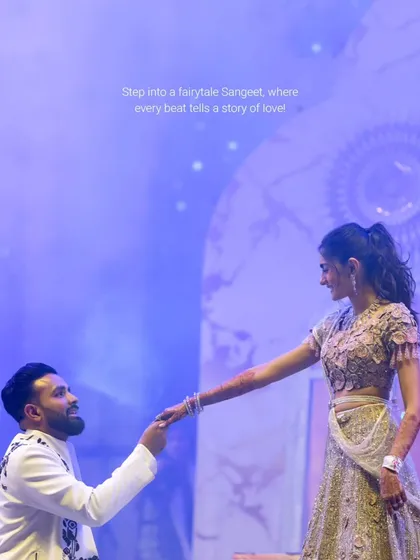 A fairytale moment on stage. The groom's romantic gesture is enhanced by a dreamy, star-lit backdrop and soft, ethereal lighting, a signature of my Sangeet design philosophy.