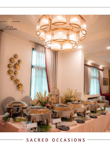 An elegant and serene buffet setup for a sacred occasion. The clean lines, white linens, and beautiful chandelier create a peaceful and respectful atmosphere.
