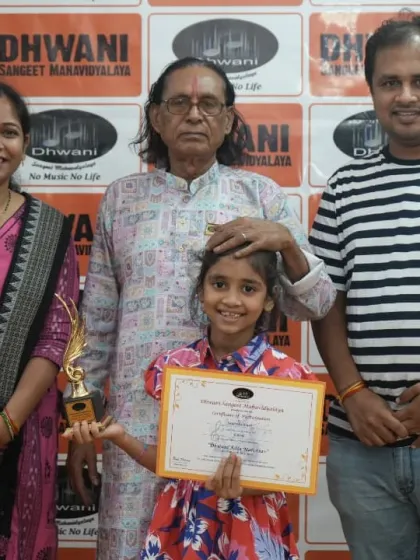 A student with her family and our senior guru, celebrating her win.